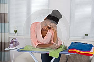 Woman Exhausted While Ironing Clothes