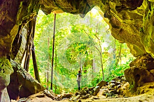 Woman in exit of dark cave