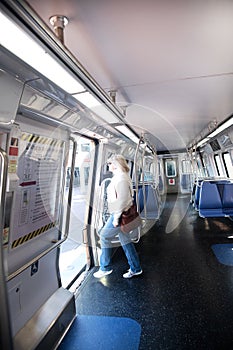 woman exits a subway car. An empty car on the Washington subway