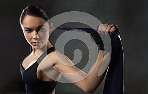 Woman with expander exercising in gym