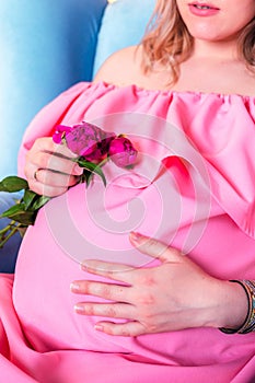 Woman expecting a baby in pink dress