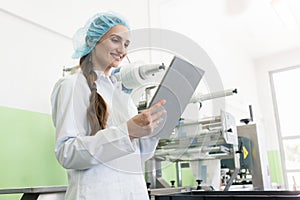 Woman expert analyzing information on tablet during work