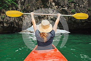 Woman explore Ha Long Bay on kayak