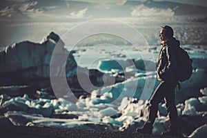 Woman explorer lookig at Jokulsarlon lagoon, Iceland.