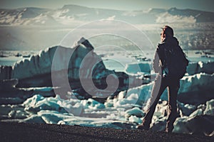 Woman explorer lookig at Jokulsarlon lagoon, Iceland.