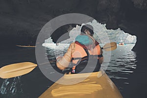 Woman explores caves with kayak