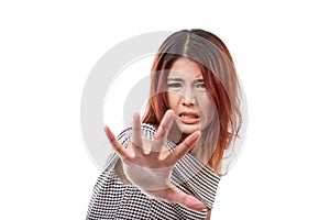 Woman with extremely fearful mood showing stop, reject, refuse photo