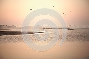 Woman exults his freedom by jumping in front of the ocean photo