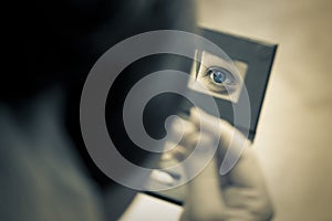 Woman eye captured in the mirror