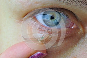 Woman eye with contact lens