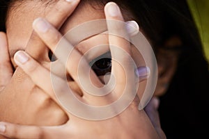 Woman, eye and face cover closeup with hiding and secret in nature with female person. Model, hands and covering