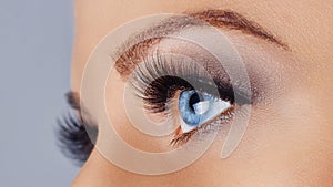 Woman eye with long eyelashes and smokey eyes make-up. Eyelash extensions, makeup, cosmetics, beauty