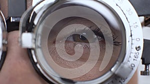 Woman eye with optical trial frame closeup, examination of visual acuity, optics