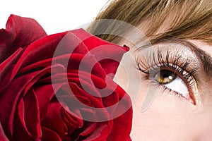 Woman eye and red rose