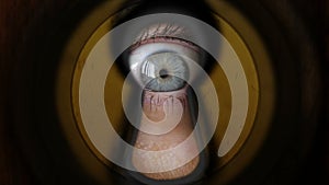 Woman eye watching through keyhole