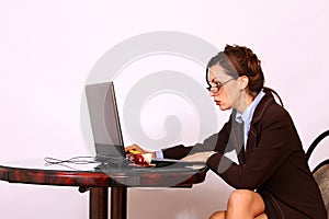 Woman with eyeglasses working on lap top computer