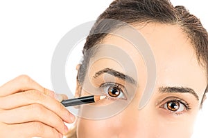 Woman with an eyeliner applying eye make up