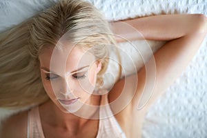 Woman, eyes closed and face for beauty, makeup or cosmetic in bedroom in Norway by above. Person, relax or calm for