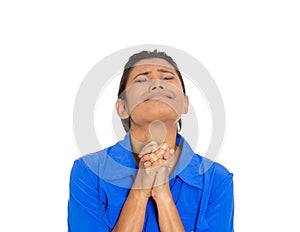 Woman eyes closed praying hoping for the best