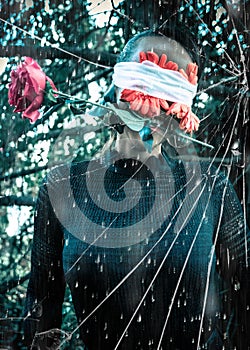 Woman with eyes covered by flowers holding a rose