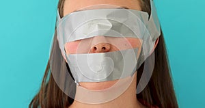 Woman with eyes and mouth covered with adhesive tape