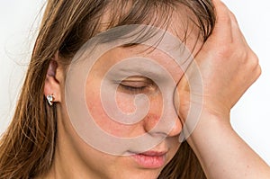 Woman with eyes pain is holding her aching eye