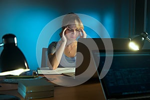 Woman With Eyes Tired Working Late At Night In Office