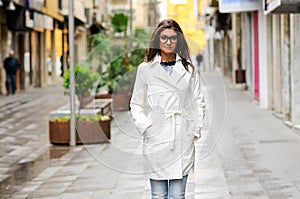 Woman with eyesglasses walking in urban background