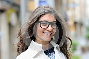 Woman with eyesglasses walking in urban background