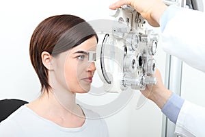 Woman eyesight measurement with optical phoropter photo