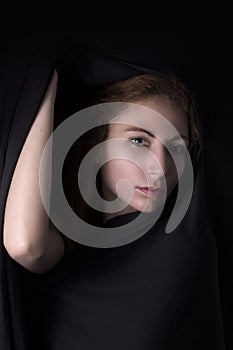 Woman face appear from black background