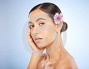 Woman, face and beauty portrait with flower in hair for skincare wellness or natural cosmetics dermatology in studio