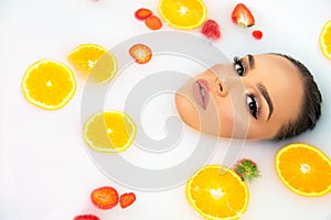 Woman face beauty portrait in milk bath