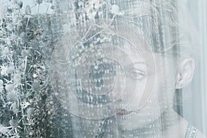 Woman face behind transparent cloth