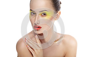 Woman face with bright yellow makeup and manicure