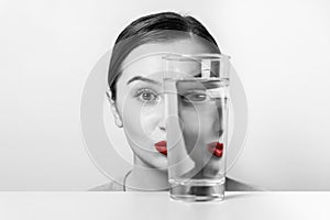 Woman Face Distortion In Water Glass