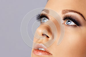 Woman face with eyes with long eyelashes and smokey eyes make-up. Eyelash makeup, cosmetics, beauty