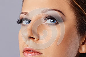 Woman face with eyes with long eyelashes and smokey eyes make-up. Eyelash makeup, cosmetics, beauty