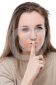 Woman face with finger near lips