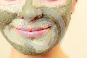 Woman face with green clay mud mask