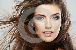 Woman face with hair motion on white background