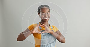 Woman, face and hands for heart in studio, love and hope for wellness and satisfaction. Black female person, portrait