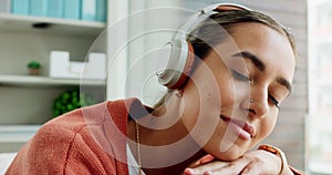 Woman, face and headphones listening to music while enjoying relaxing and thinking at home. Contemplate, think and