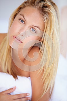 Woman, face and looking with portrait for lying on bed for relaxing, rest or peace in home. Closeup, person and pose for