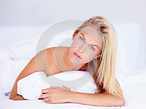 Woman, face and looking with portrait for lying on bed for relaxing, rest or peace in home. Female person, think and