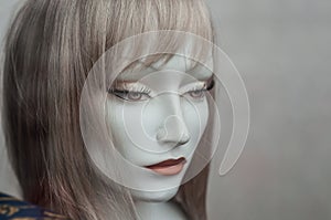 Woman face of mannequin with wig in fashion store sho