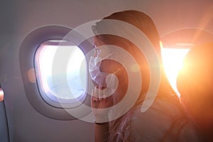 Woman in a Face Mask in Airplane