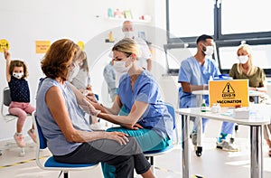 Woman with face mask getting vaccinated, coronavirus, covid-19 and vaccination concept. photo