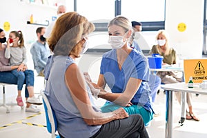 Woman with face mask getting vaccinated, coronavirus, covid-19 and vaccination concept.