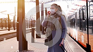 Woman in face mask at railway station in winter